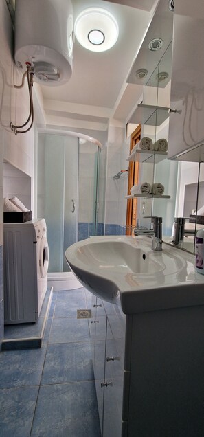 Shower, hair dryer, towels, soap