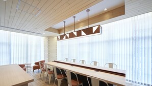 A conference room with a long table, six chairs, and a modern pendant light fixture. - Sotetsu Fresa Inn Osaka-Namba (Osaka)