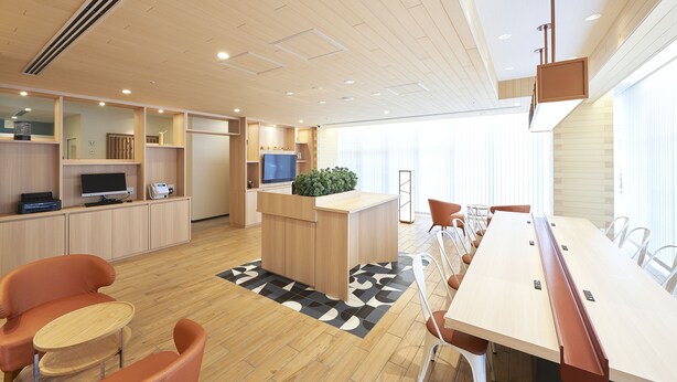 A modern hotel room with a wooden ceiling, a reception desk, a TV, and a large window. - Sotetsu Fresa Inn Osaka-Namba (Osaka)