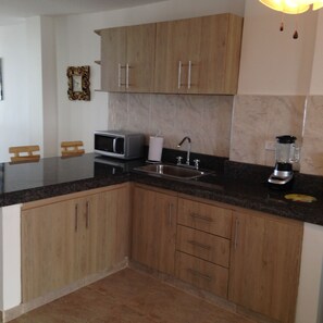 Fridge, stovetop, cookware/dishes/utensils, dining tables