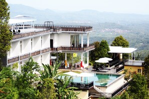 Enjoy panoramic views from our rooftop terrace, featuring a swimming pool and outdoor seating areas.