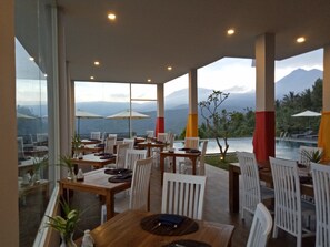 Enjoy a meal with a breathtaking view of the surrounding mountains and serene landscape.