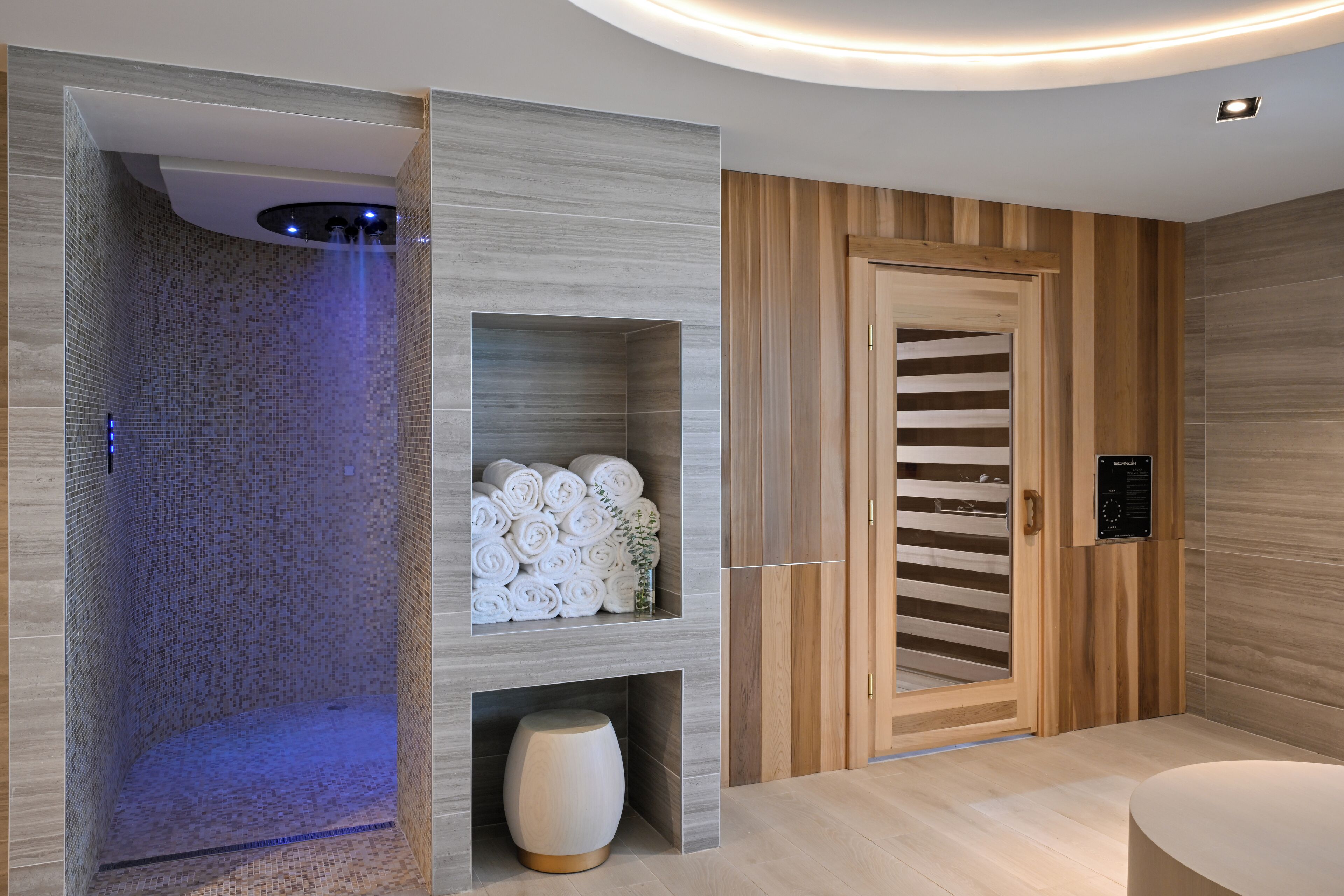 Une salle de bain moderne avec une douche, un meuble-lavabo en bois et un porte-serviettes intégré.