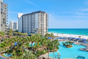 A resort with a large pool surrounded by palm trees, a beach, and high-rise buildings. - ⛵Corner Unit-Gulf Views-Pools-Edgewater Tower 1-412⛵ (Panama City Beach)