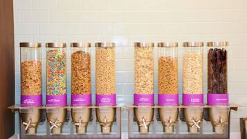A cereal dispenser with various brands and flavors.