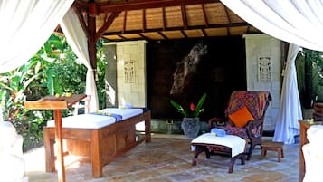 Relax in a serene outdoor oasis with a bench, table, and lush green surroundings.