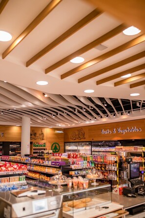 A grocery store interior with a 'Fruits & Vegetables' section, wooden ceiling beams, and a variety of packaged goods on shelves. - Arguineguin Park By Servatur VV (Mogan)