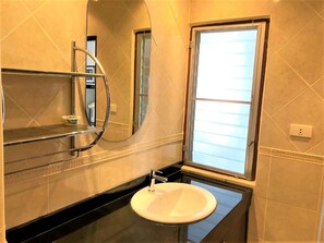A bathroom with a white sink, a mirror, and a window. - Top Floor Spacious Studio (Pattaya)