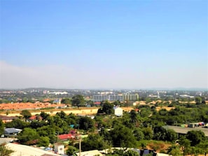 A residential area with a mix of houses and a large building, possibly a hotel, with a clear sky. - Sea View Studio Jomtien (Pattaya)