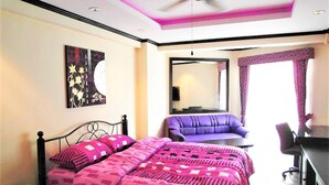 A bedroom with a bed, a sofa, a desk, and a ceiling fan. - Stylish Studio Rentbuythailand (Pattaya)