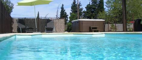 A heated pool, sun loungers