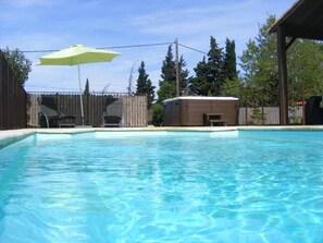 Et oppvarmet basseng og solsenger