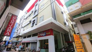 A multi-story building with a sign for Hotel Maa Gangga Palace. - Hotel Maa Ganga palace (Bhopal)