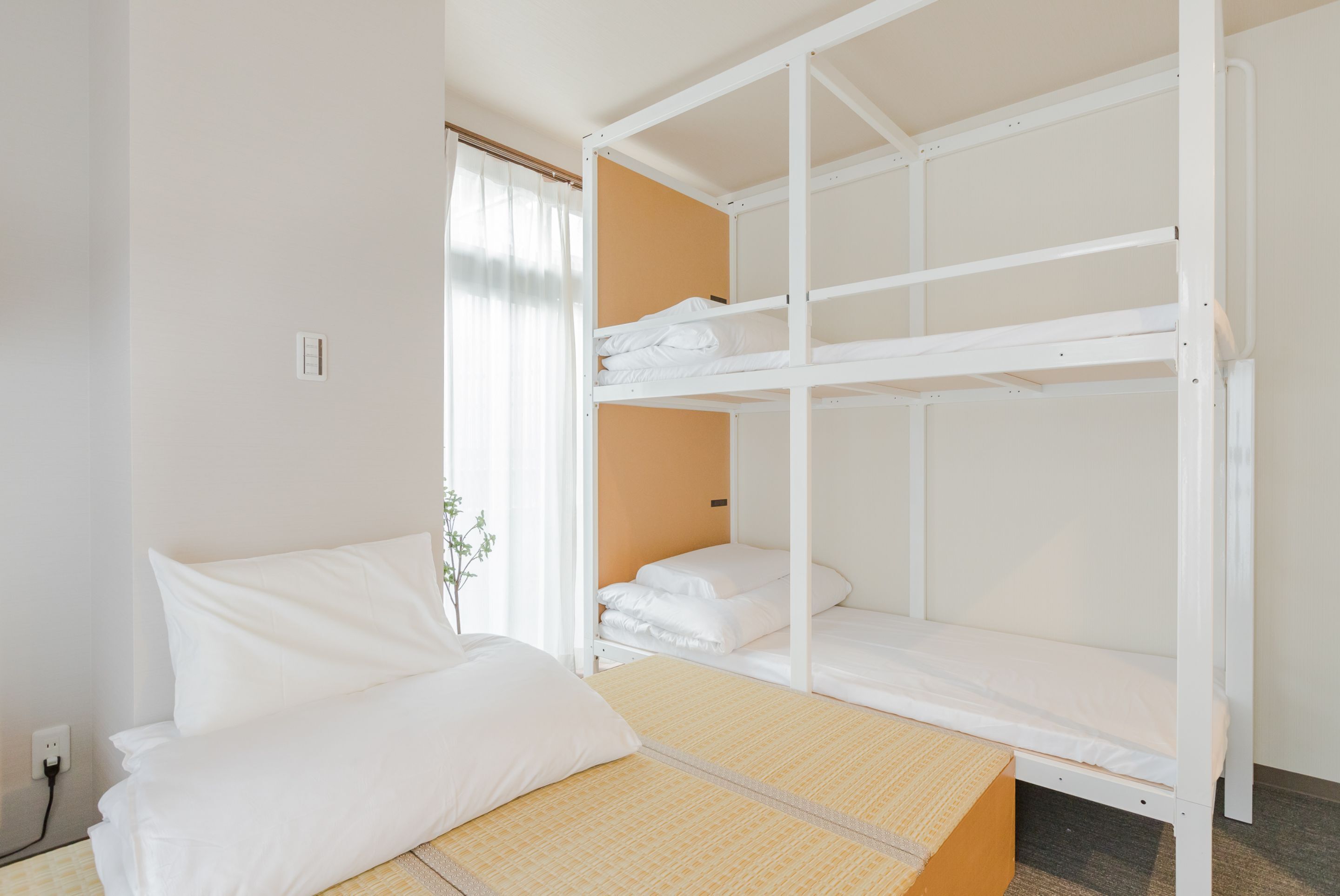 A bunk bed room with a single bed and a bunk bed.