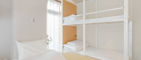 A bunk bed room with a single bed and a bunk bed.