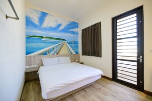 A bedroom with a bed, a wooden headboard, a painting of a pier and water, and a door with horizontal bars. - Township Season B&B (Magong)