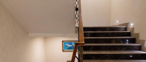 A staircase with a handrail and a picture frame on the wall.