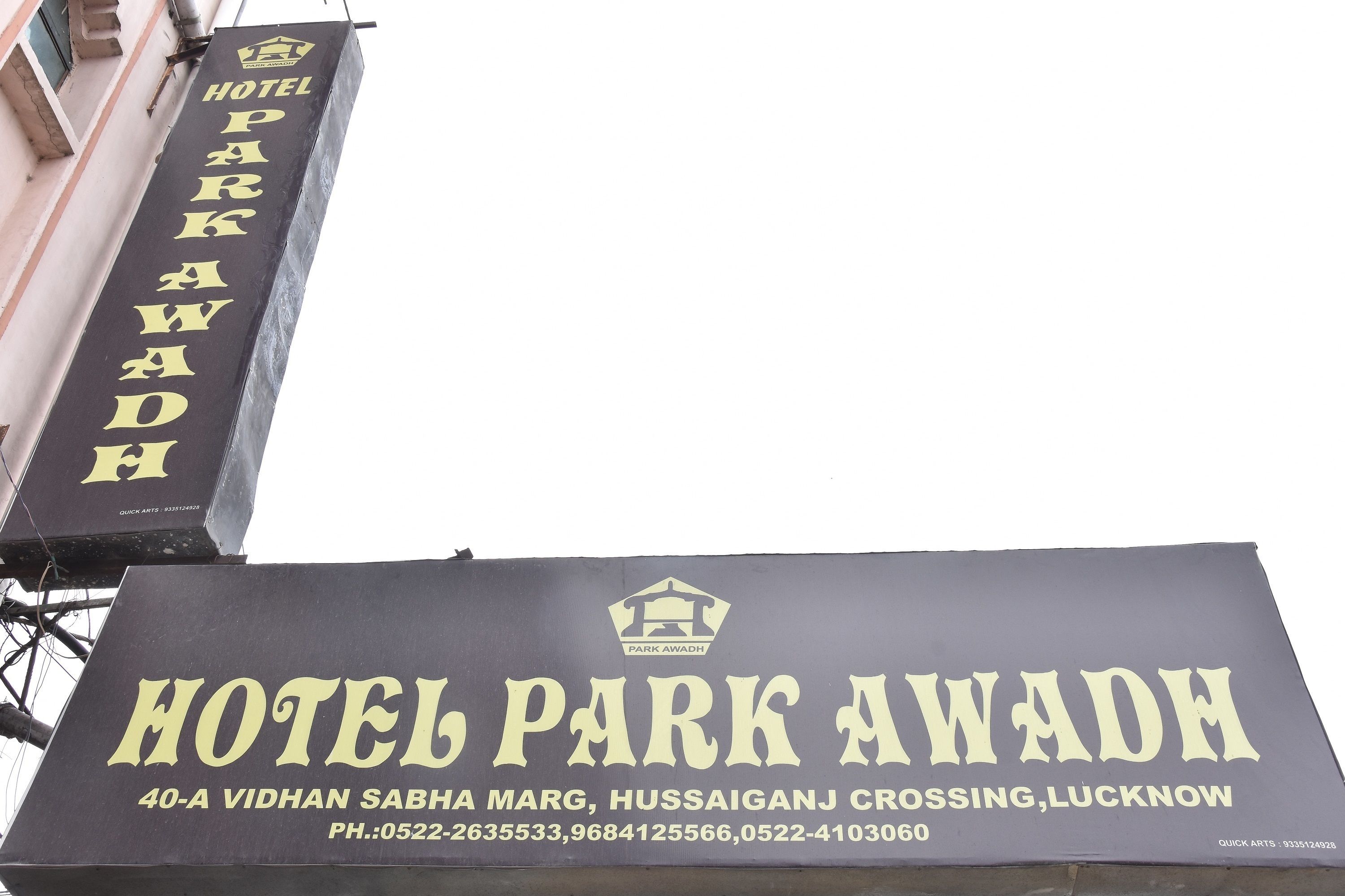 A sign for Hotel Park Awadh, including its address and contact numbers.
