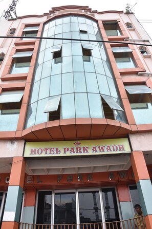 A hotel with a modern facade, featuring large glass windows and a prominent sign reading "HOTEL PARK AWADH". - Park Awadh (Lucknow)