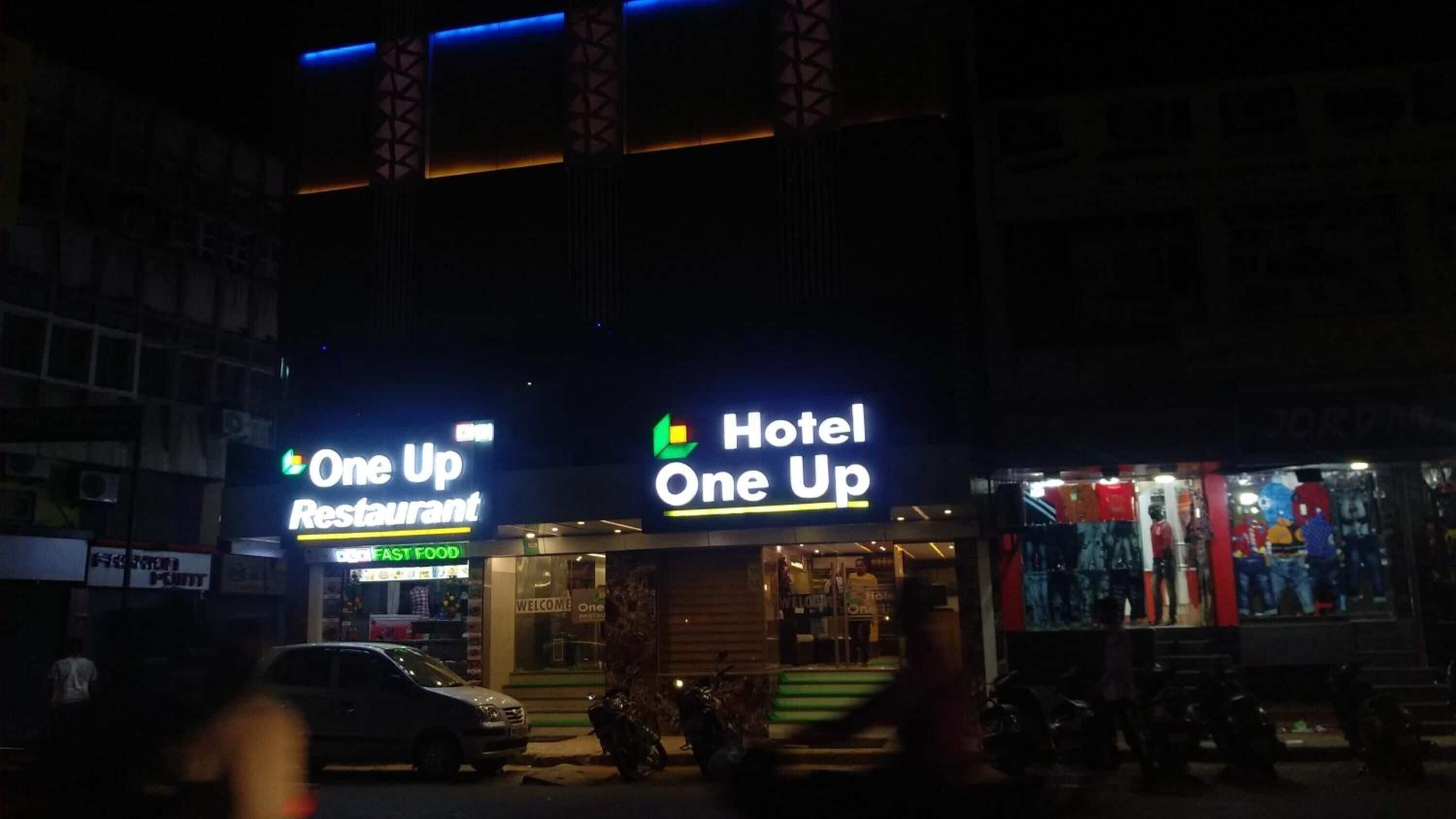 A building with a 'One Up Restaurant' and 'Hotel One Up' sign.