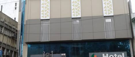 A building with a 'Grill n Rice Restaurant' and 'Hotel One Up' signs.