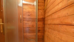 A wooden cabin bathroom with a shower stall and a toilet. - Lovely apartment in villa for 2 guests with A/C, WIFI, TV and terrace (Biograd Na Moru)