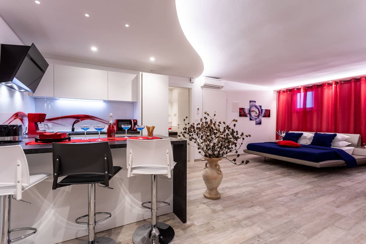 A modern apartment with a kitchen, dining area, and living room.