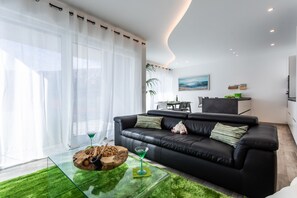 Deluxe Apartment, 2 Bedrooms, Sea View | Living area | 55-inch flat-screen TV with premium channels, Smart TV, Netflix