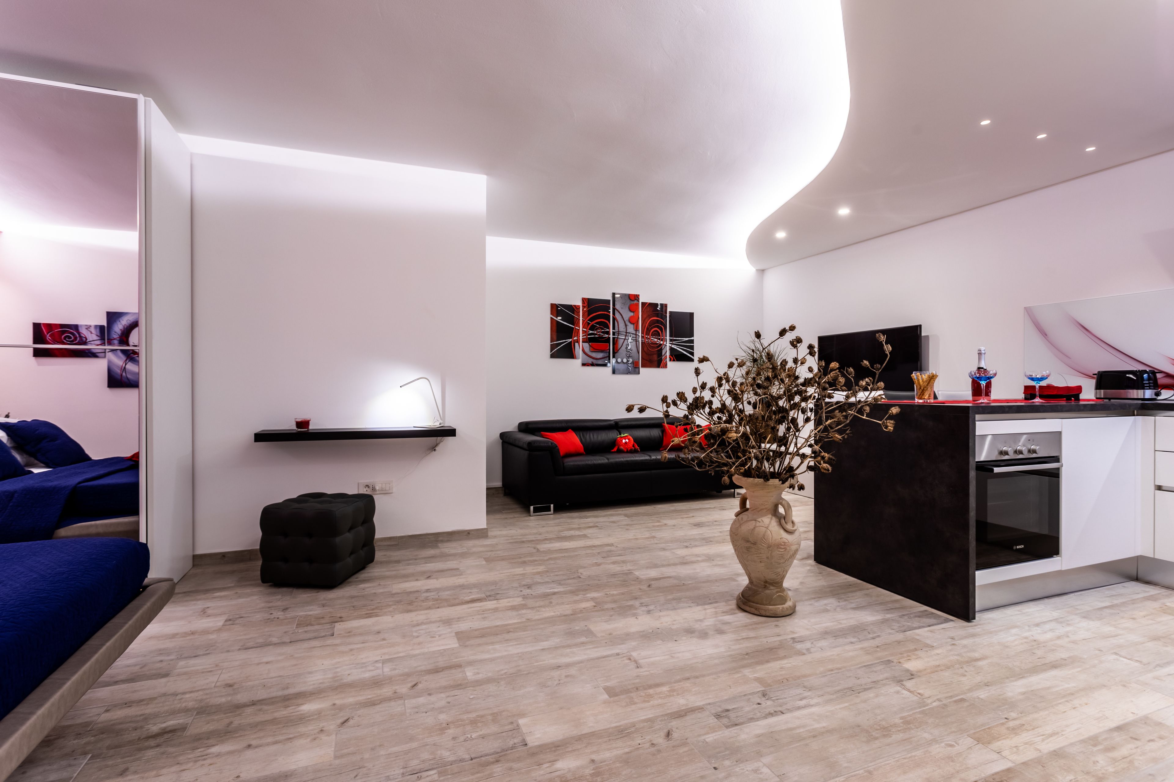 A modern living room with a sofa, a coffee table, and a decorative vase.