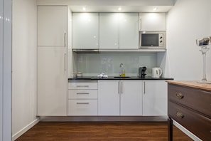 Fridge, microwave, stovetop, coffee/tea maker