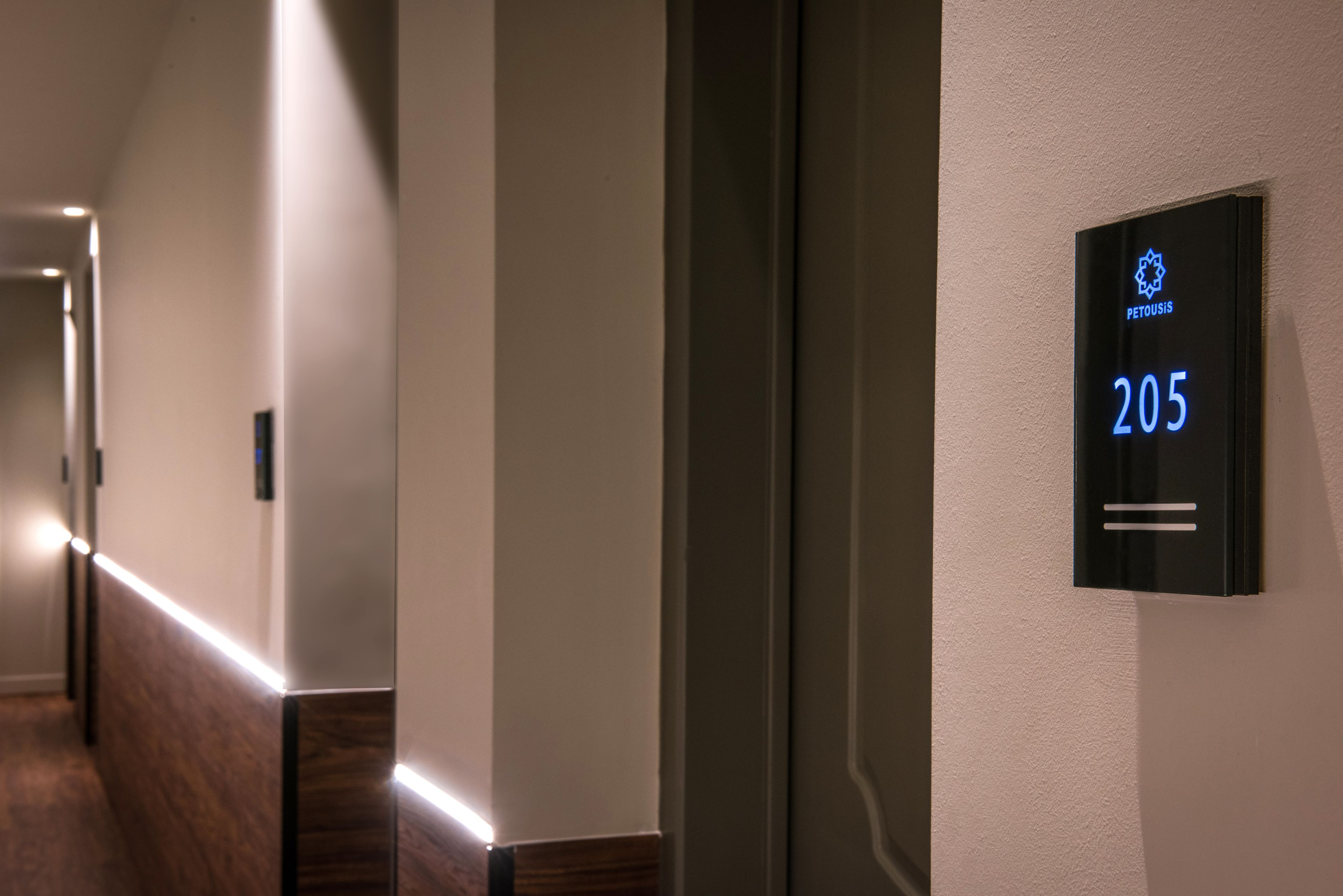 A hallway with a digital sign displaying the number 205.