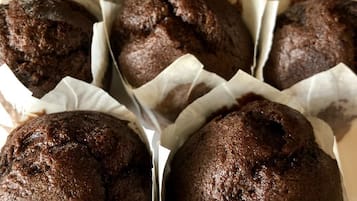 A tray of chocolate muffins in paper liners.