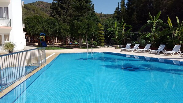 Outdoor pool, open 8:00 AM to 8:00 PM, pool umbrellas, pool loungers