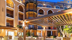 A multi-level hotel atrium with outdoor seating and a central tower. - The Grand Resort Hurghada (Hurghada)