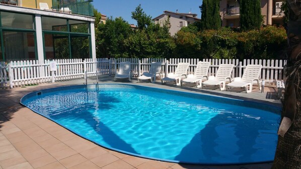 Seasonal outdoor pool, pool umbrellas, pool loungers
