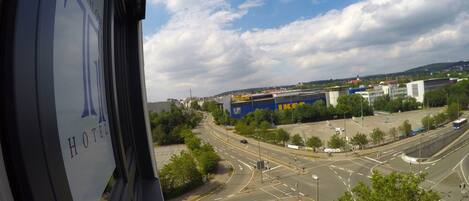 A view of a road with a roundabout, a large IKEA store, and a hotel sign in the foreground.