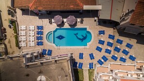 An aerial view of a hotel with a swimming pool, arranged lounge chairs, and umbrellas. - The Barn by CorfuEscapes (Corfu)
