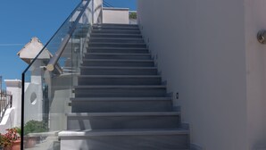 A set of modern, wide stairs leading up to a building with a glass railing. - The Barn by CorfuEscapes (Corfu)