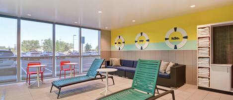 A modern indoor relaxation area with lounge chairs, a sofa, and a small table.