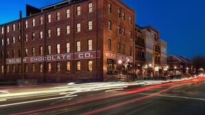 A historic brick building with a sign reading "Wilbur Chocolate Co." - The Wilbur Lititz, Tapestry Collection by Hilton (Lititz)