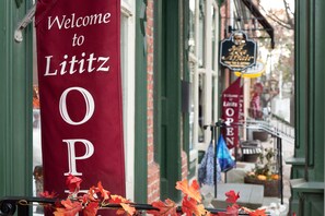A red banner with "Welcome to Lititz" and "OPEN" signs, indicating a business establishment. - The Wilbur Lititz, Tapestry Collection by Hilton (Lititz)