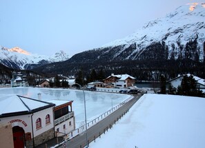 A snow-covered mountain landscape with a building labeled "Country Club" in the foreground. - Centrally located apartment house, about 10 minutes walk from St. (St. Moritz)