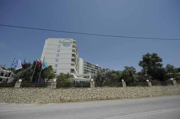 A modern hotel with a stone facade and multiple balconies. - Evia Riviera Resort by Anayia All Inclusive Resorts (Eretria)