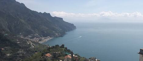 A coastal village with terraced houses, a church, and a view of the sea.