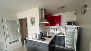A modern kitchen with a microwave, toaster, and coffee machine.