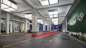 A modern hotel lobby with a green wall, large windows, and a clean, spacious design. - Lake Front-Private Beach Access- Golf - all within walking distance (Panama City)