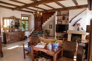 TV connectée, cheminée, table de tennis de table, livres