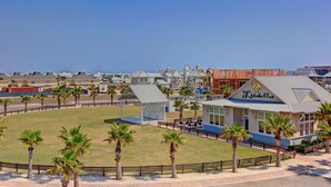 A coastal hotel with a prominent 'Lisabelas' sign, surrounded by palm trees and a fenced lawn. - Cinnamon Shore- Porter Ansas TC 3302 (Port Aransas)
