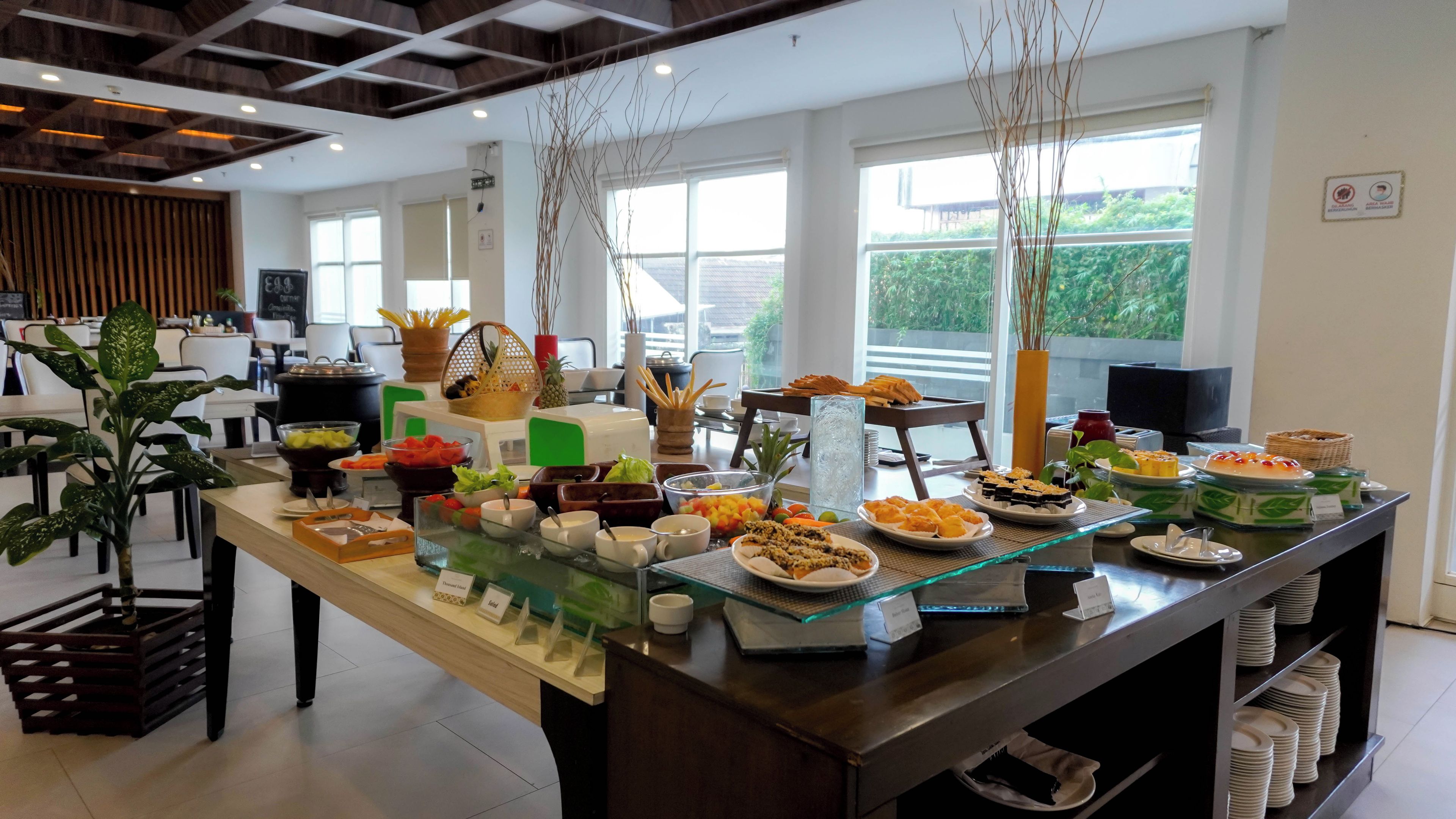 A buffet setup with various food items and a glass display case.