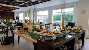 A buffet setup with various food items and a glass display case.
